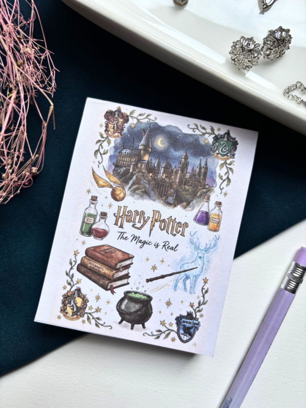 A7 Harry Potter wizarding world themed tear-off notepad with illustrated magical cover art, placed on a dark aesthetic desk surface with warm lighting