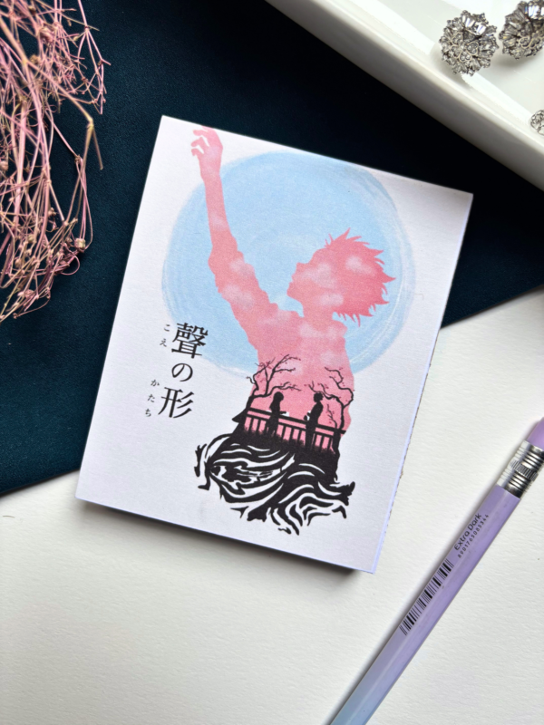 A7 A Silent Voice Koe no Katachi anime tear-off memopad with soft illustrated cover art, placed on a light pastel aesthetic desk surface
