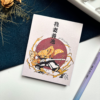A7 Zenitsu Agatsuma Demon Slayer Kimetsu no Yaiba tear-off memopad with illustrated anime cover art featuring lightning motifs, on a clean aesthetic desk surface