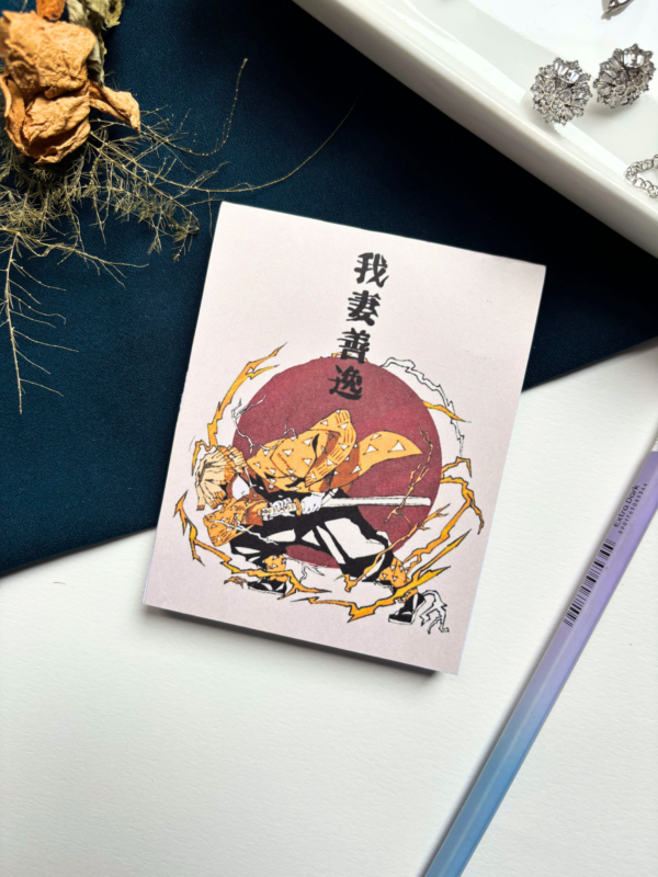 A7 Zenitsu Agatsuma Demon Slayer Kimetsu no Yaiba tear-off memopad with illustrated anime cover art featuring lightning motifs, on a clean aesthetic desk surface