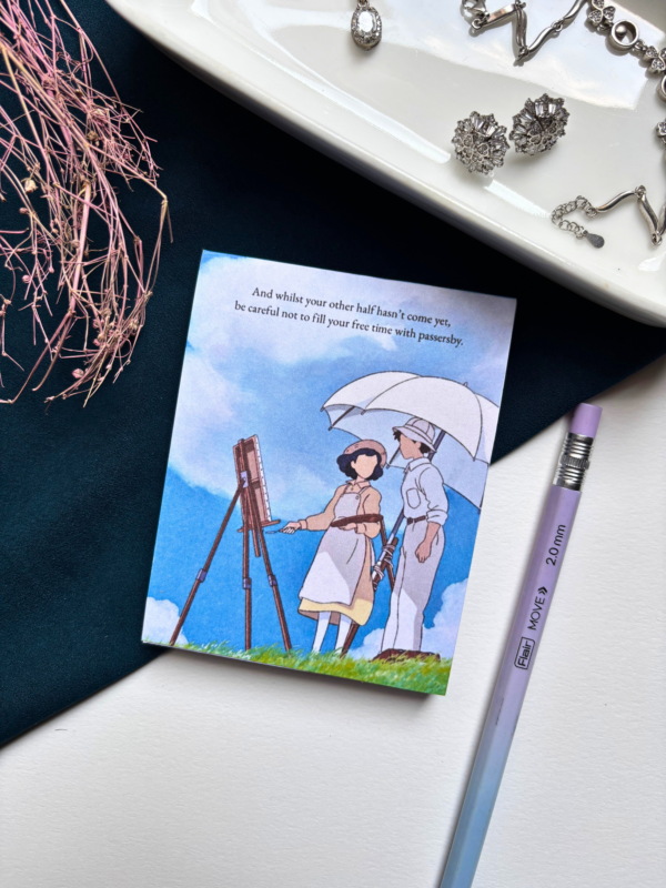 A7 Studio Ghibli The Wind Rises tear-off memopad with illustrated cover art showing a dreamy sky scene, placed on a light aesthetic desk surface