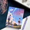 A7 Your Name Kimi no Na wa anime tear-off notepad with illustrated cover art featuring a twilight sky and comet, placed on a clean aesthetic desk surface