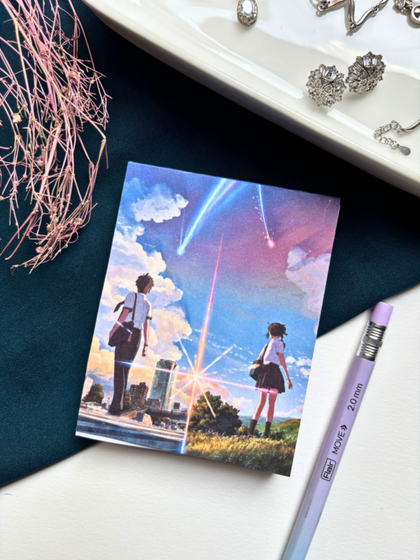 A7 Your Name Kimi no Na wa anime tear-off notepad with illustrated cover art featuring a twilight sky and comet, placed on a clean aesthetic desk surface