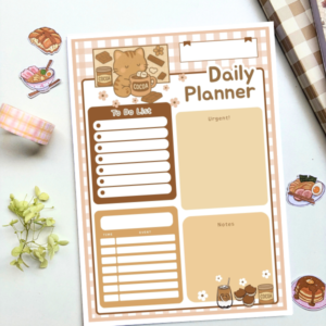 A5 daily planner with a pink gingham border featuring a cocoa kitten illustration, including sections for to-do list, urgent tasks, time/event schedule, and notes.