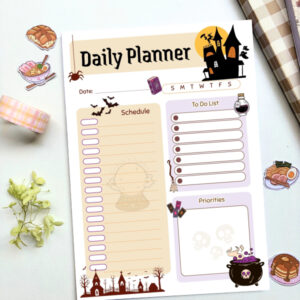 A5 daily planner with a witchy Halloween theme featuring a haunted house, crystal ball, cauldron, bats, and graveyard illustrations, with sections for schedule, to-do list, and priorities.