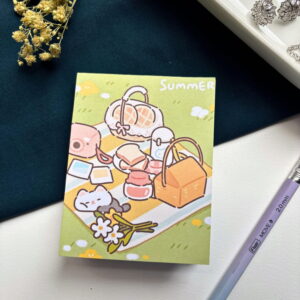 A7 memopad with a cute kitten summer picnic illustrated cover.