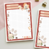 Grid notepad with a terracotta border featuring a bear reading, tiny mice, coffee cups, paw prints, and a cottage illustration, with Date and Title fields at the top.