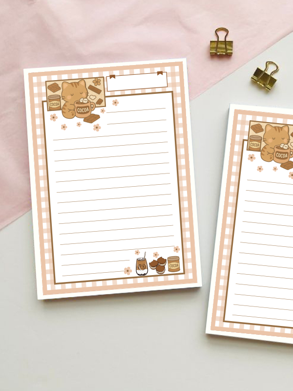 Lined notepad with a pink gingham border featuring a kitten holding a cocoa mug, chocolate bars, cocoa tin, iced coffee, and muffins, with a blank title label at the top.