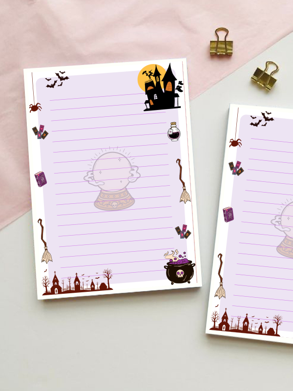 Lined notepad with a lavender background featuring a crystal ball, bats, spider, tarot cards, potion bottles, broomsticks, a cauldron, a haunted house, and a graveyard.