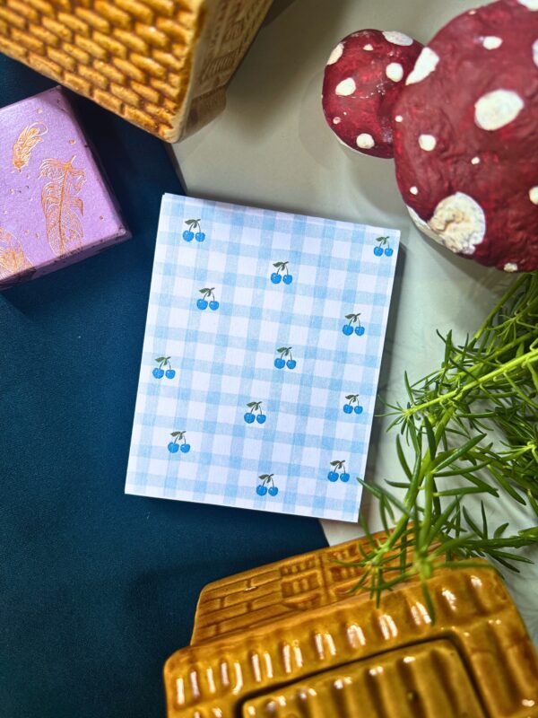 Blue cherry checkered memopad featuring cute cherry illustrations on a blue checkered pattern background, aesthetic notepad design.