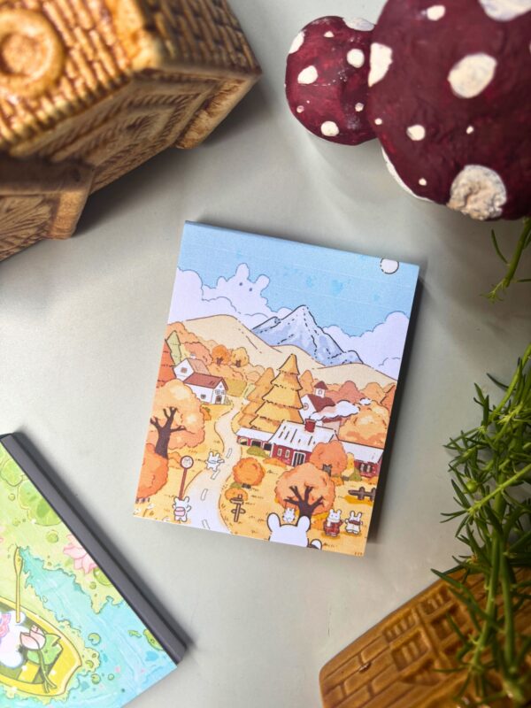 Blue and yellow bear village memopad featuring an illustrated scene of bears in a cozy village, aesthetic storybook-style notepad design.