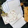 Once Upon a Time vintage letter set with 4 printed letter sheets and 2 matching printed envelopes featuring ornate gold crests and fairy tale-inspired baroque details.