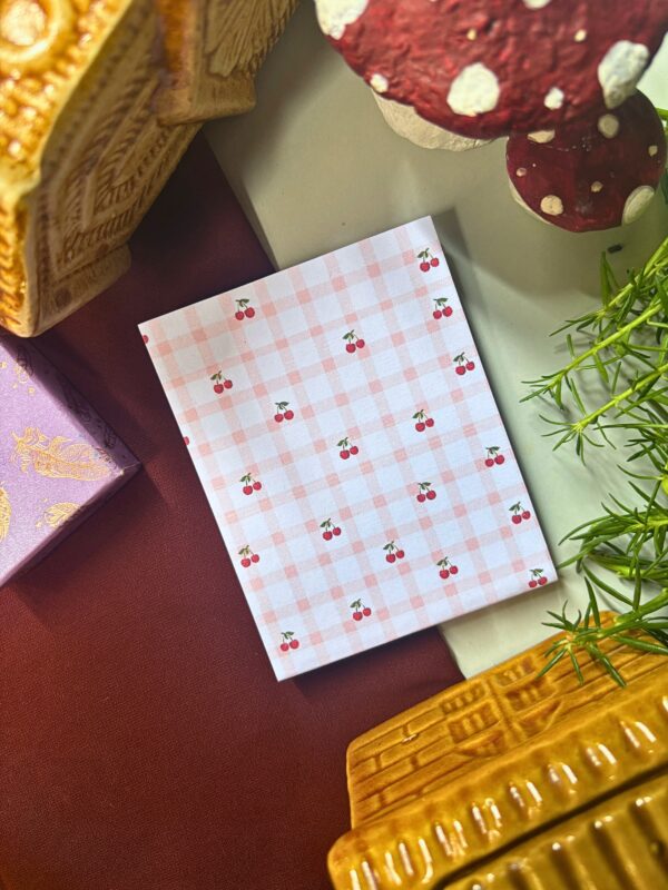 Cherry checkered memopad featuring cute cherry illustrations on a checkered pattern background, aesthetic retro-inspired notepad design.