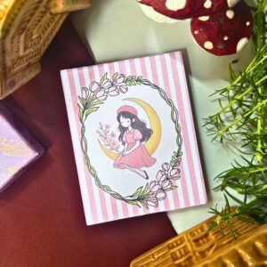 Moonfairy memopad featuring a pastel pink illustration of a fairy girl sitting on a crescent moon, aesthetic celestial-themed notepad design.