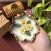 Handcrafted 3.5-inch lotus urli candle with detailed lotus petals in a small traditional urli bowl, glowing softly