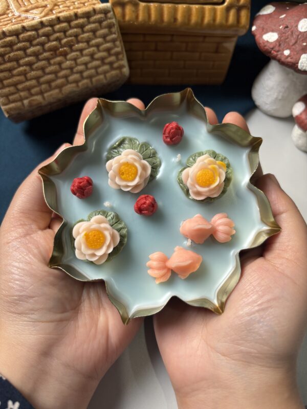 Handcrafted 4-inch lotus urli candle with detailed lotus petals in a traditional urli bowl, glowing softly on a table